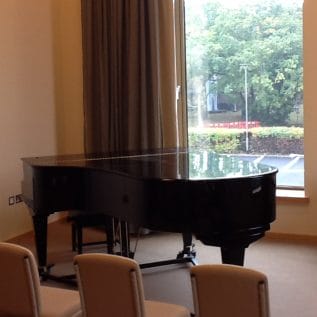 Piano standing in a practice room