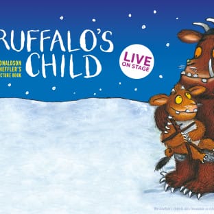 The gruffalo cuddles its child in the snow