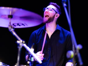 Man in glasses drumming