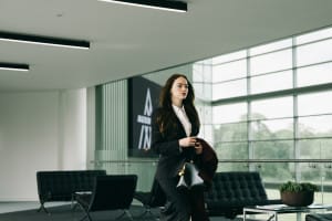 Woman in suit walking through an office