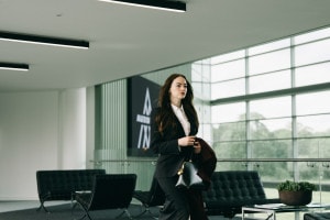 Woman in suit walking through an office