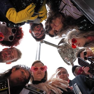 group of people looking down at camera