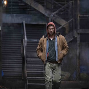 Man in hoodie walking down steps