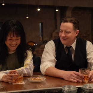 Man and woman laughing at bar