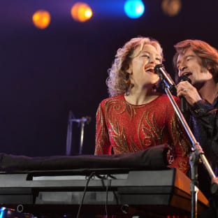 Man and woman singing on stage