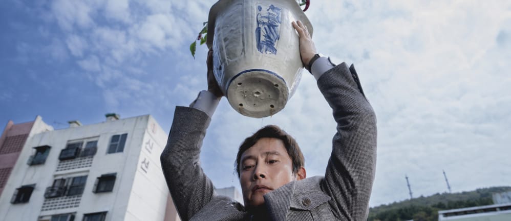 Man holding a flower pot up