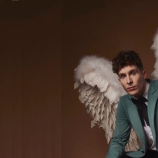 Man in green suit with angel wings