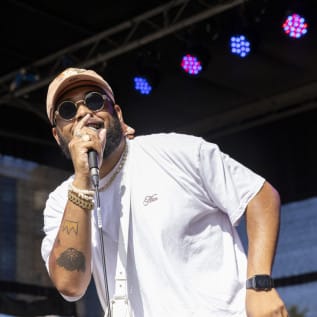 Man with sunglasses singing into microphone