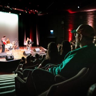 Man in audience watching stage performance